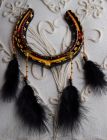 Black with yellow dreamcatcher, black fluffy feathers. SOLD.